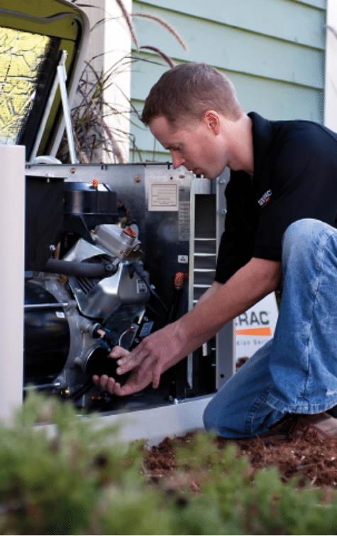 A technician performing maintenance on a backup generator.